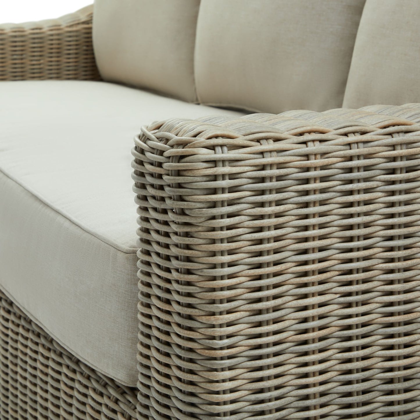 Wicker style outdoor sofa with cream cushions