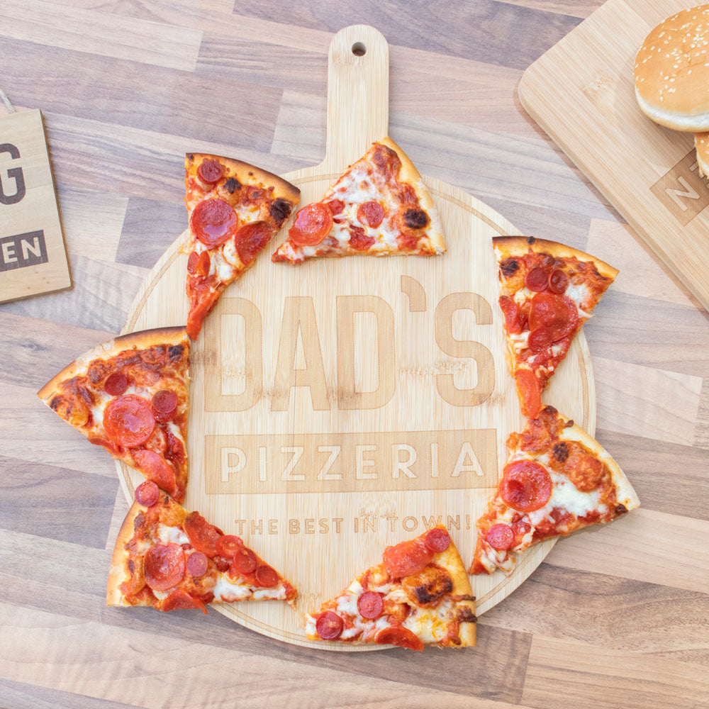 Circular serving board featuring words ‘Dad’s Pizzeria, the best in town!’