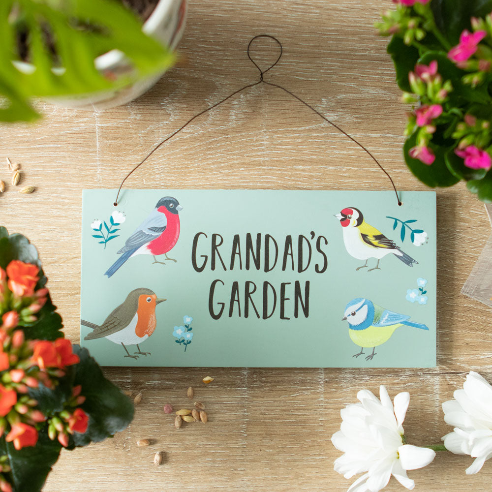 A rectangular hanging sign for the garden featuring the words 'Grandad's Garden' and a painting of a bird in each corner