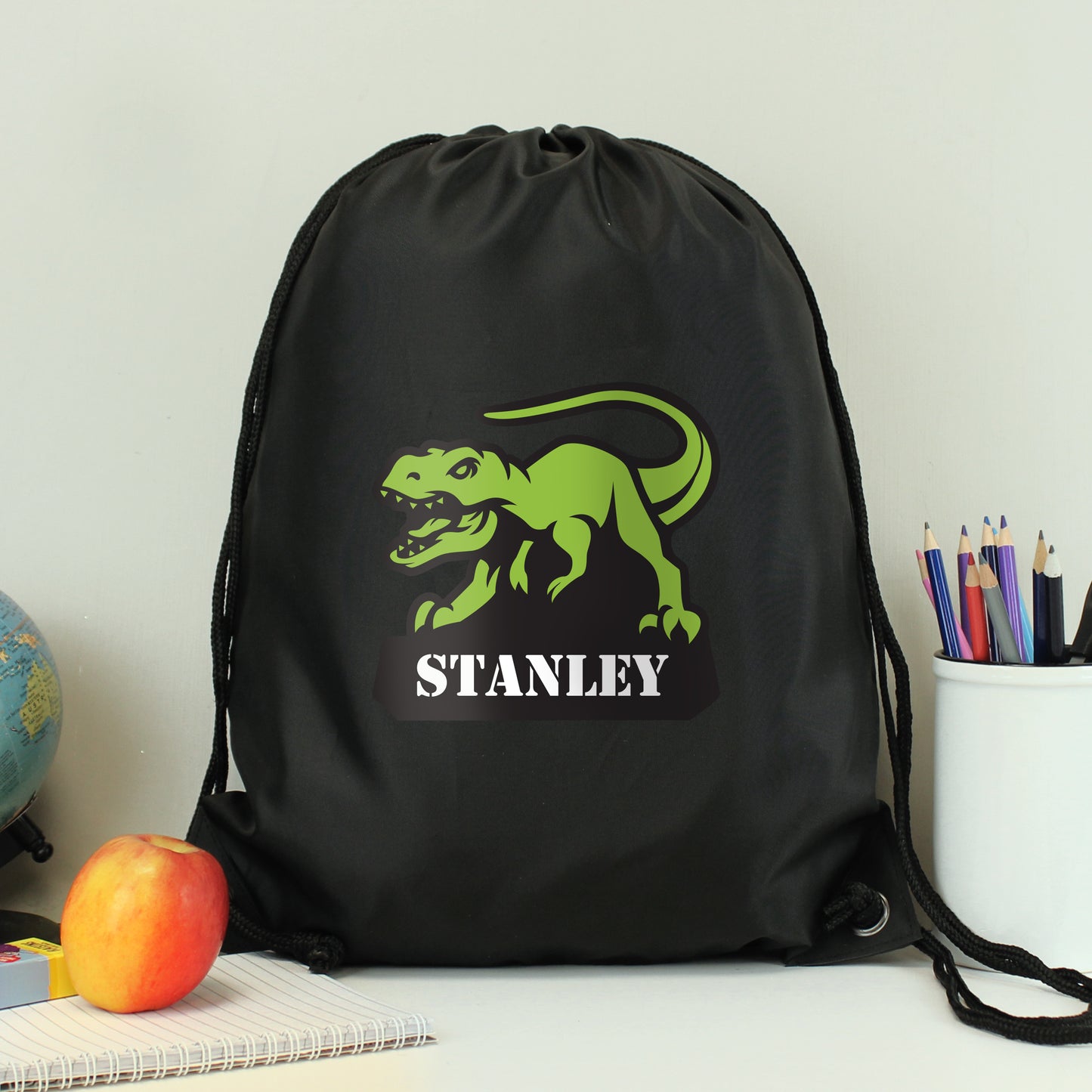 Black drawstring kit bag with dinosaur picture and personalised names