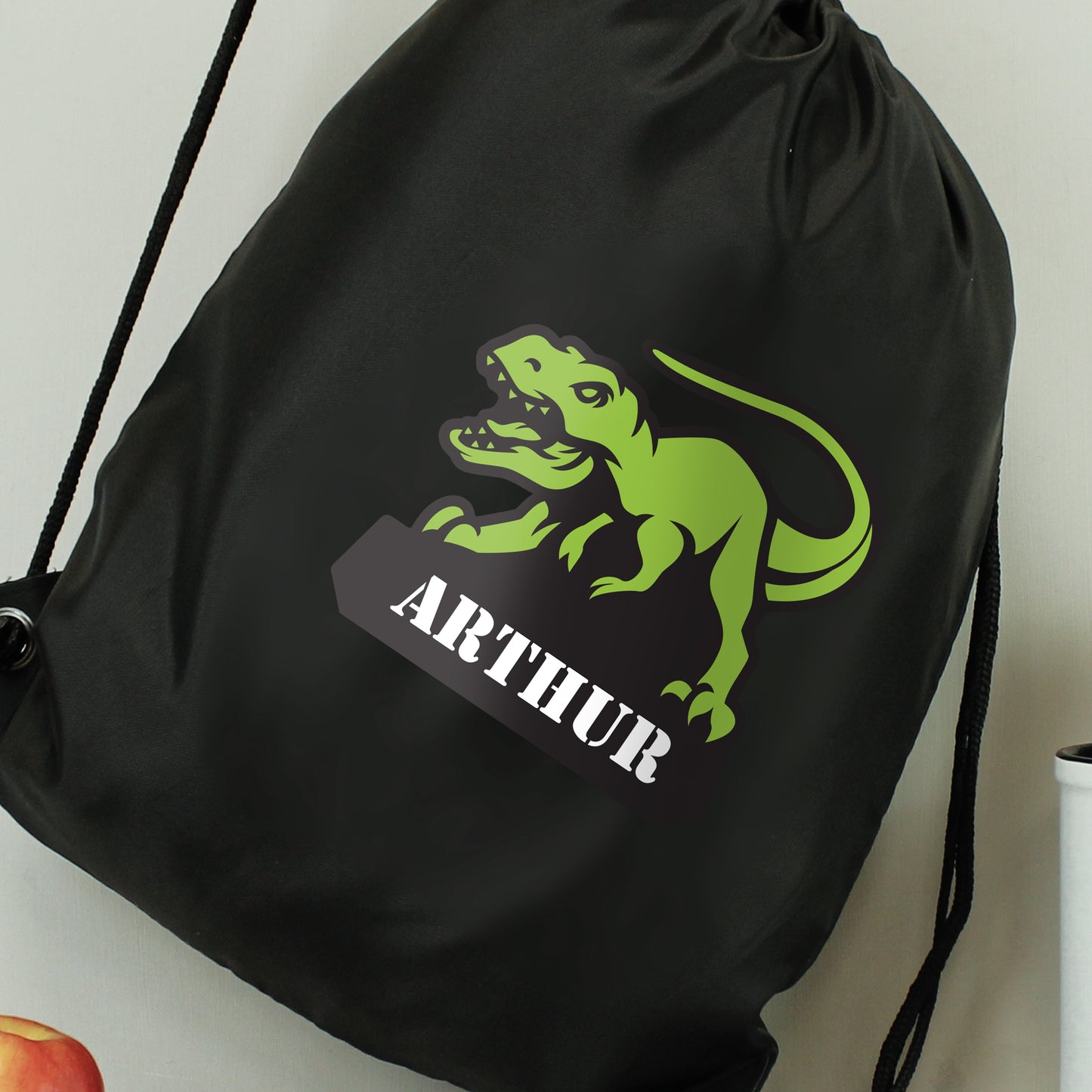 Black drawstring kit bag with dinosaur picture and personalised names