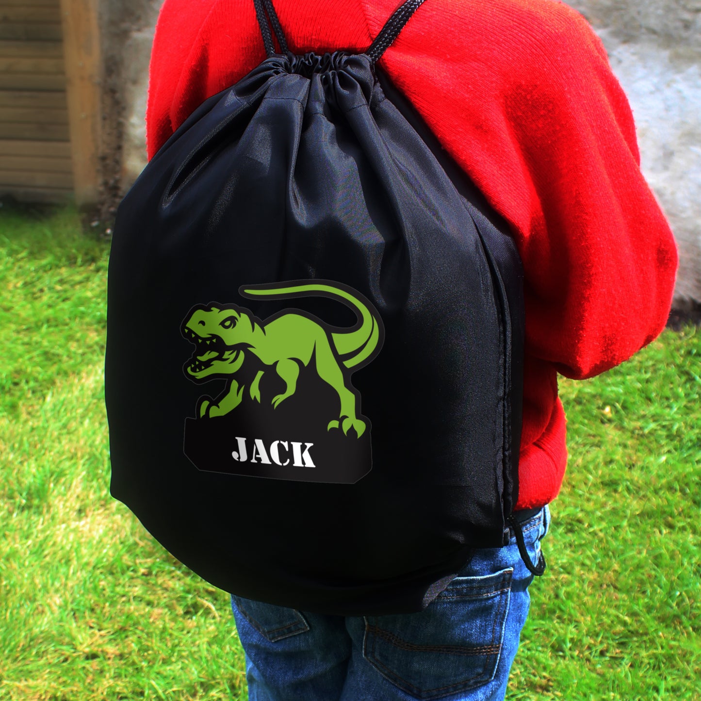 Black drawstring kit bag with dinosaur picture and personalised names