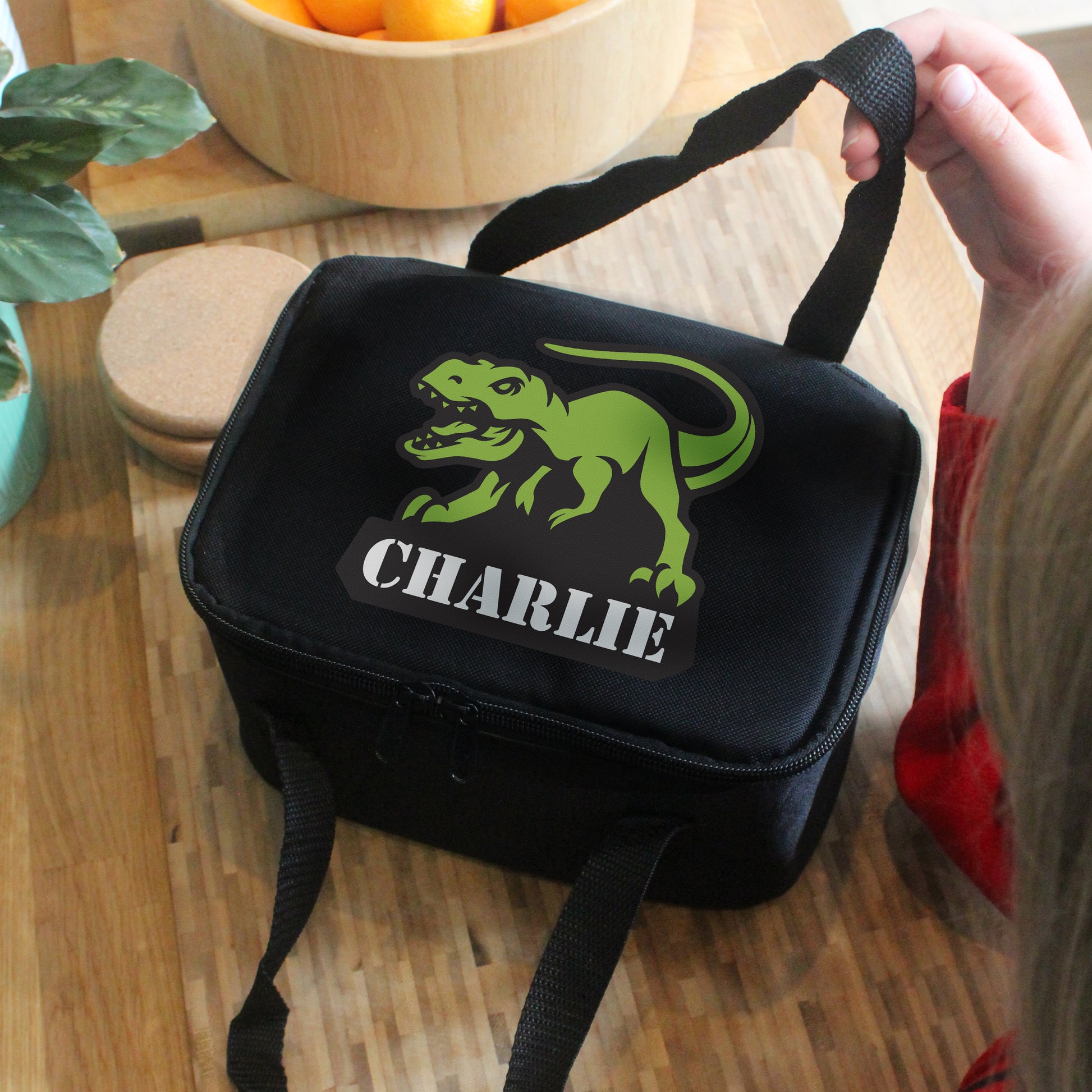 Black lunch bag with picture of t-Rex and personalised with a name