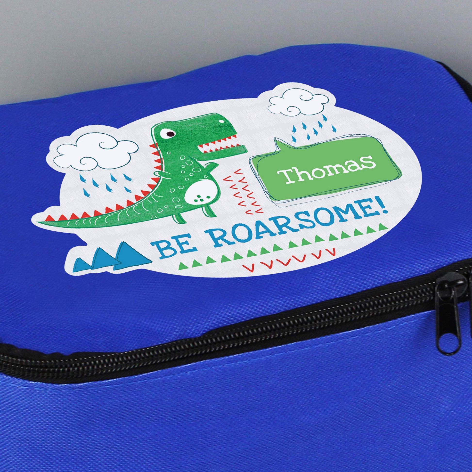 Blue lunch bag with dinosaur picture and personalised with name 