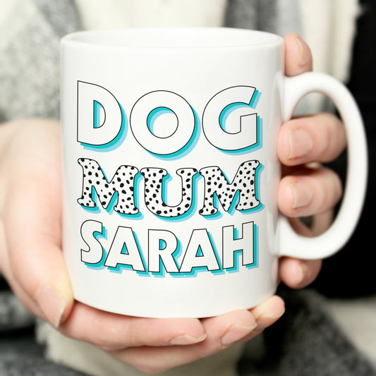 White mug with words ‘dog mum’ and name of choice go be added. Blue and black colours for wording. 