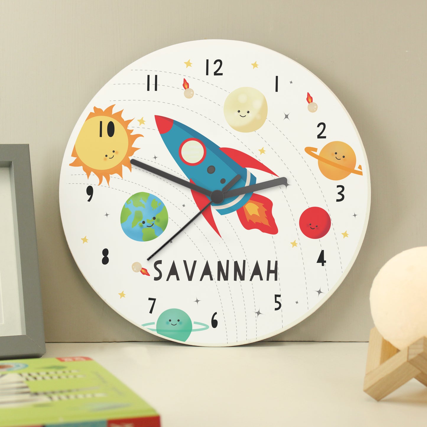 Clock with space rocket and planets