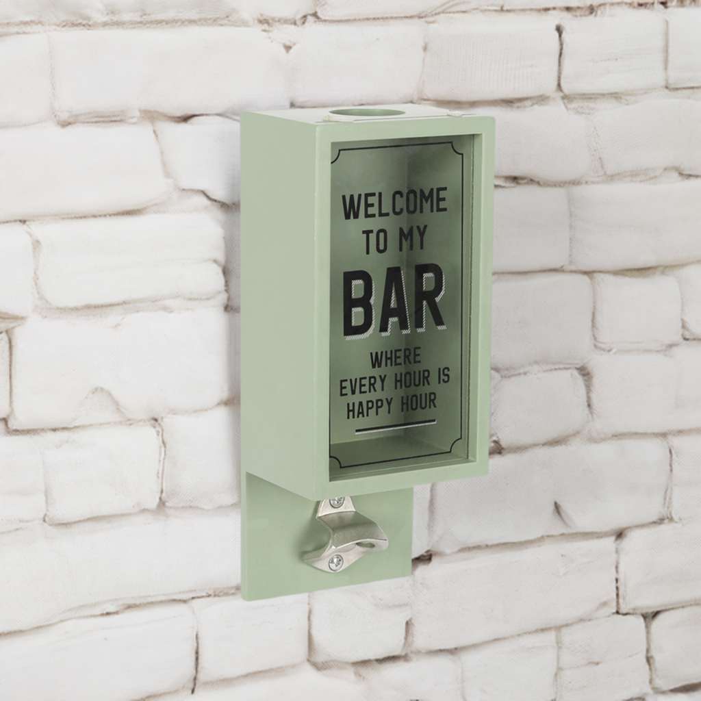 A wall mounted bottle opener with words ‘welcome to my bar’ and a box for collecting lids 